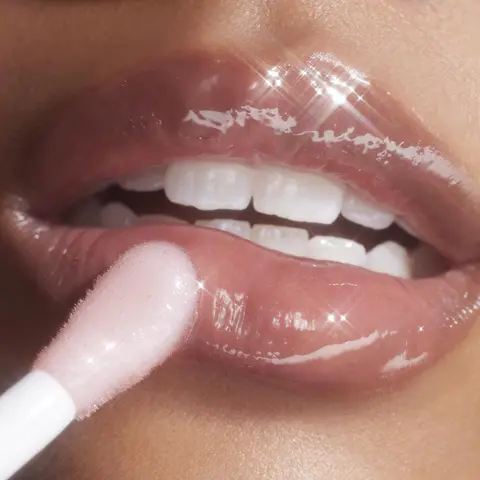 An image of the product going on a models lips